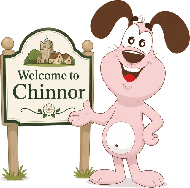 Marley the MyWaggyTails mascot beside a Welcome to Chinnor sign